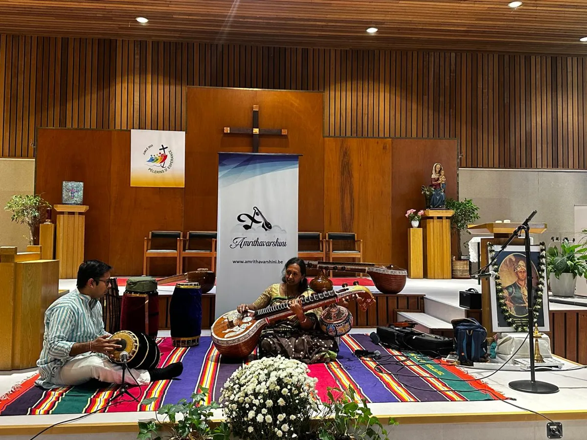 Kousalya playing veena with mridangam accompaniment on stage in Brussels