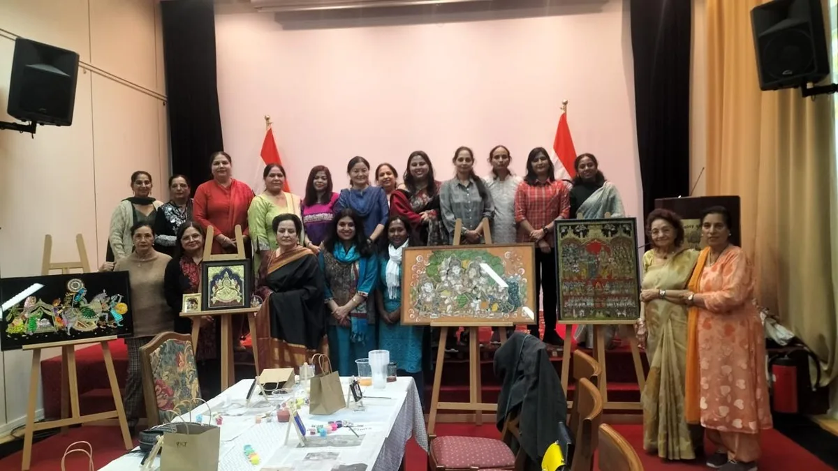 Workshop participants standing with Thanjavur paintings on easels